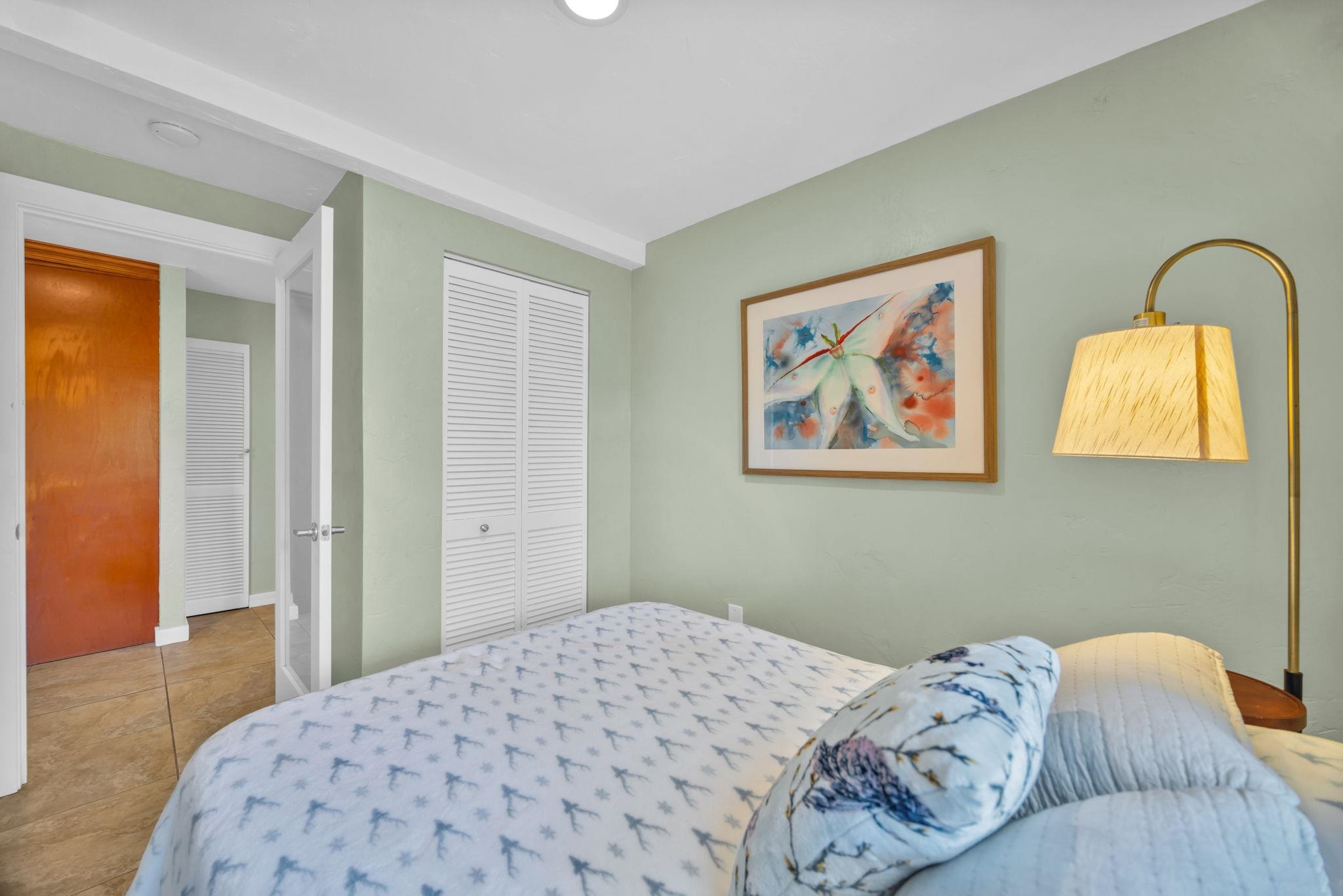 620 Awalau Road Haiku, HI 96708 - Photo 30 of 50 a bedroom with a bed and a painting on the wall