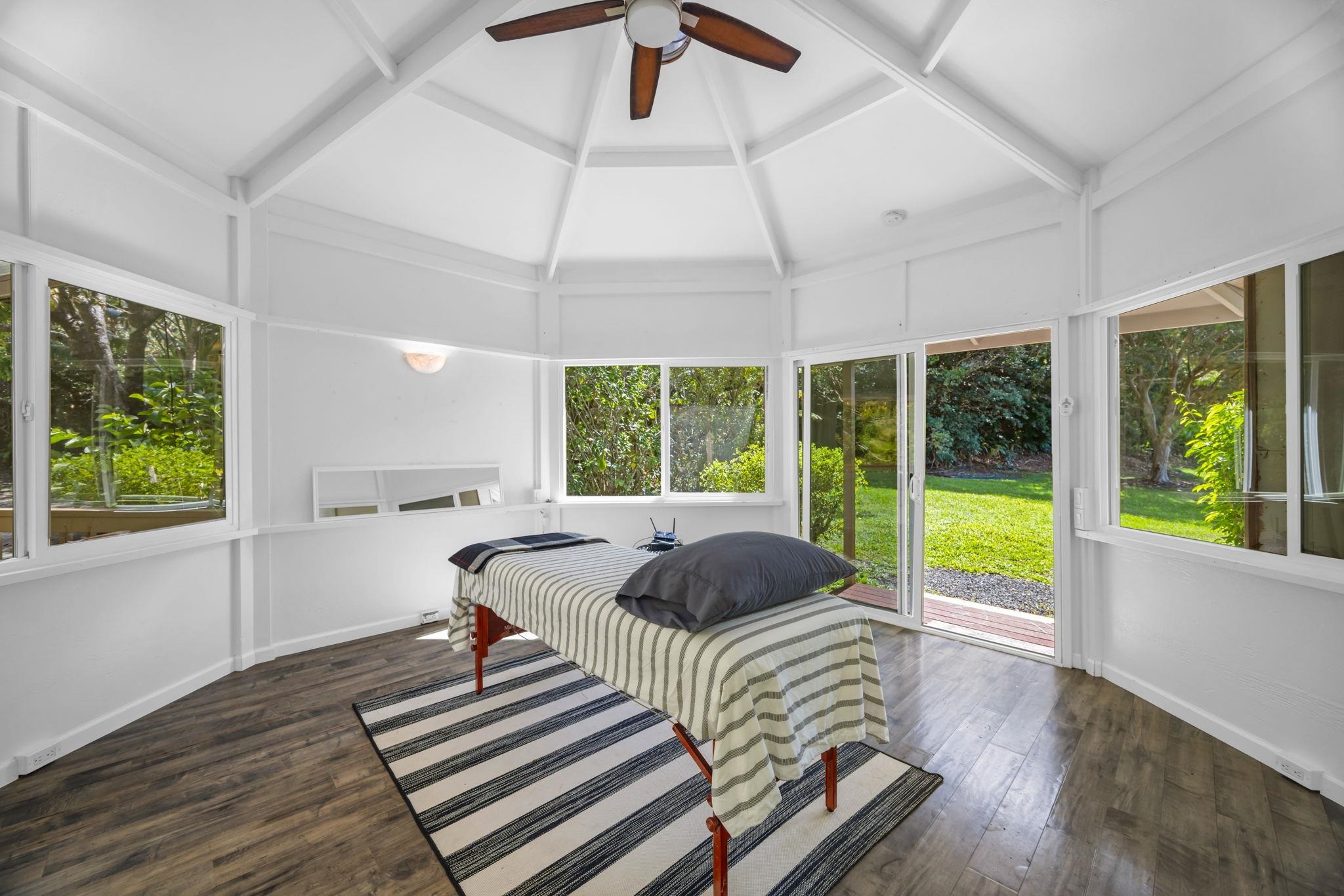 620 Awalau Road Haiku, HI 96708 - Photo 40 of 50 a bedroom with a bed and a large window