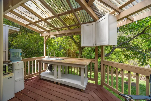 a view of a wooden chairs on the deck