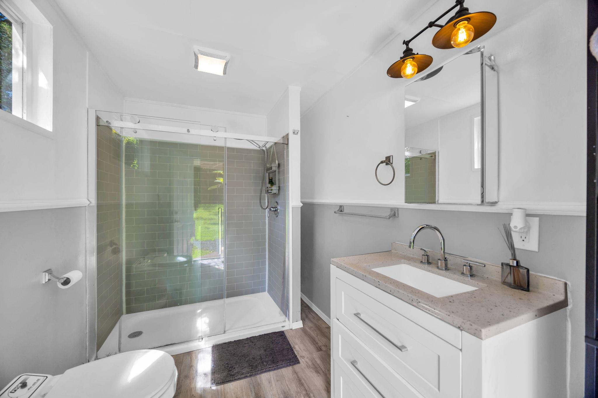 620 Awalau Road Haiku, HI 96708 - Photo 43 of 50 a bathroom with a granite countertop sink and a mirror
