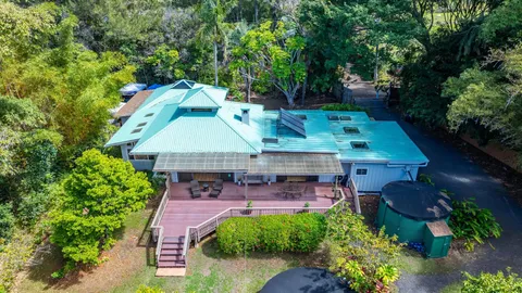 an aerial view of a house with table and chairs & potted plants