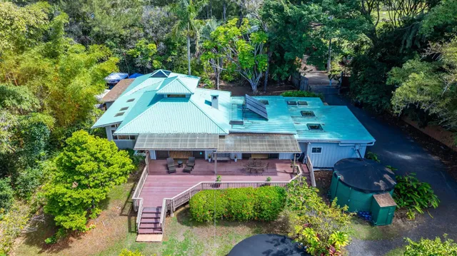an aerial view of a house with table and chairs & potted plants