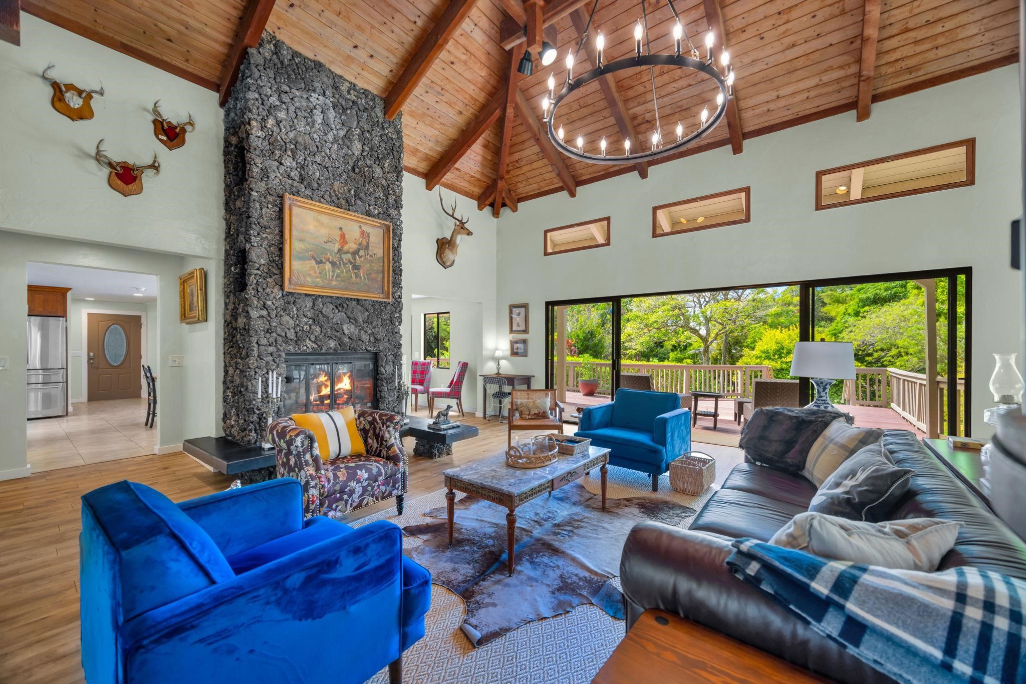 620 Awalau Road Haiku, HI 96708 - Photo 7 of 50 a living room with furniture a fireplace and a large window