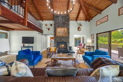 a living room with furniture a fireplace and a large window