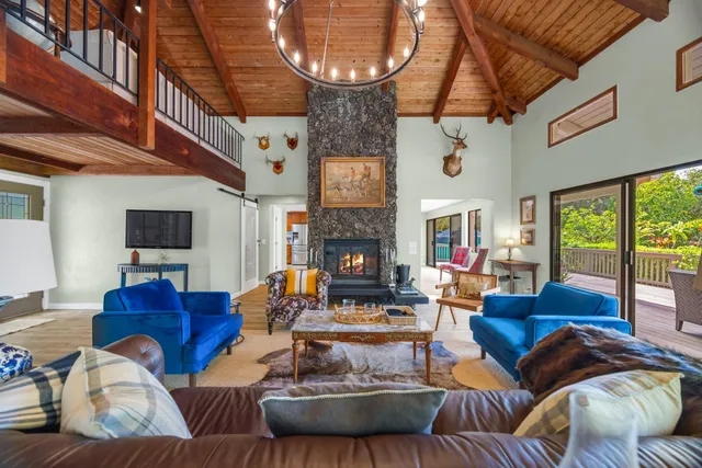 a living room with furniture a fireplace and a large window