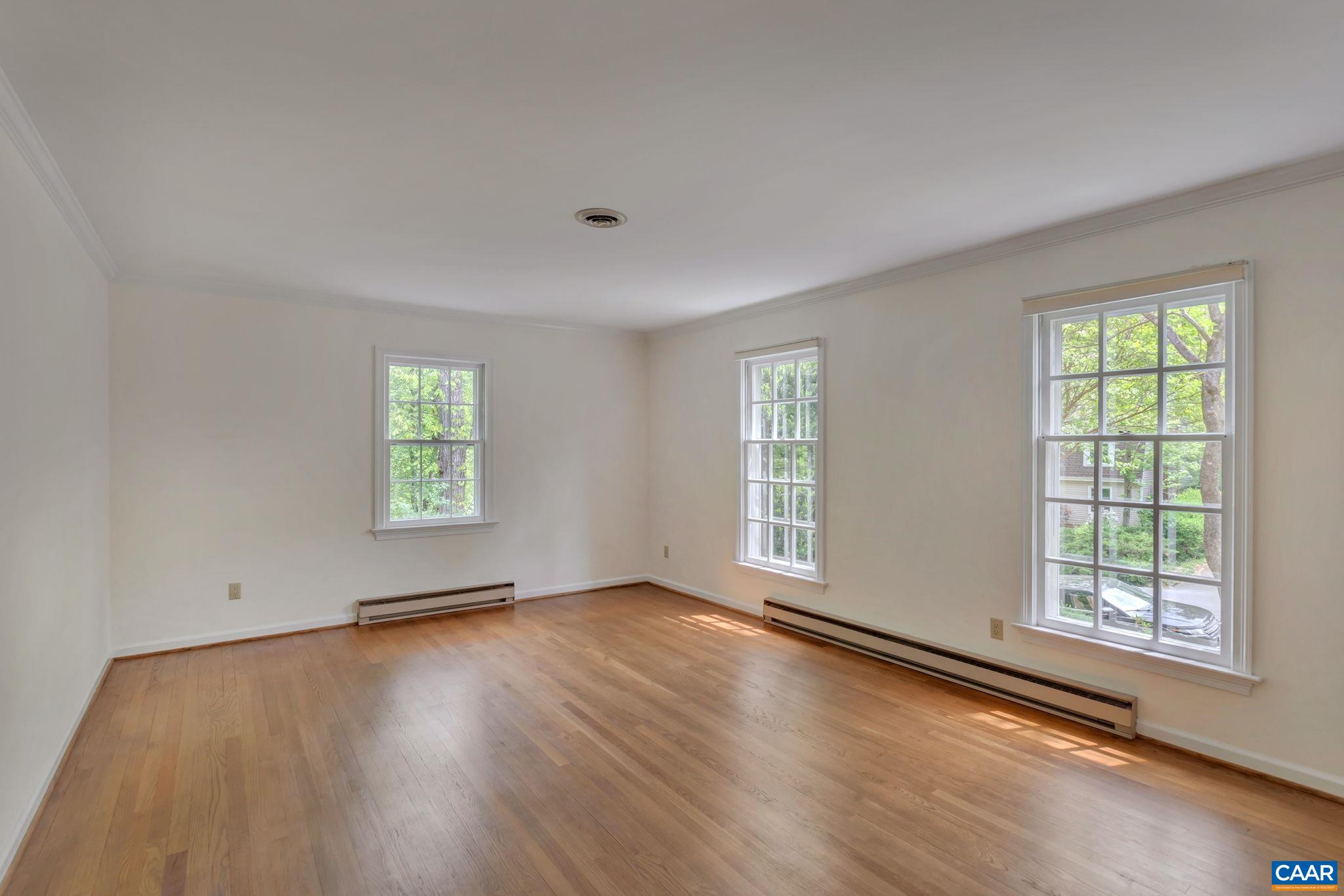 309 Westminster Road Charlottesville, VA 22901 - Photo 5 of 40 an empty room with wooden floor and windows