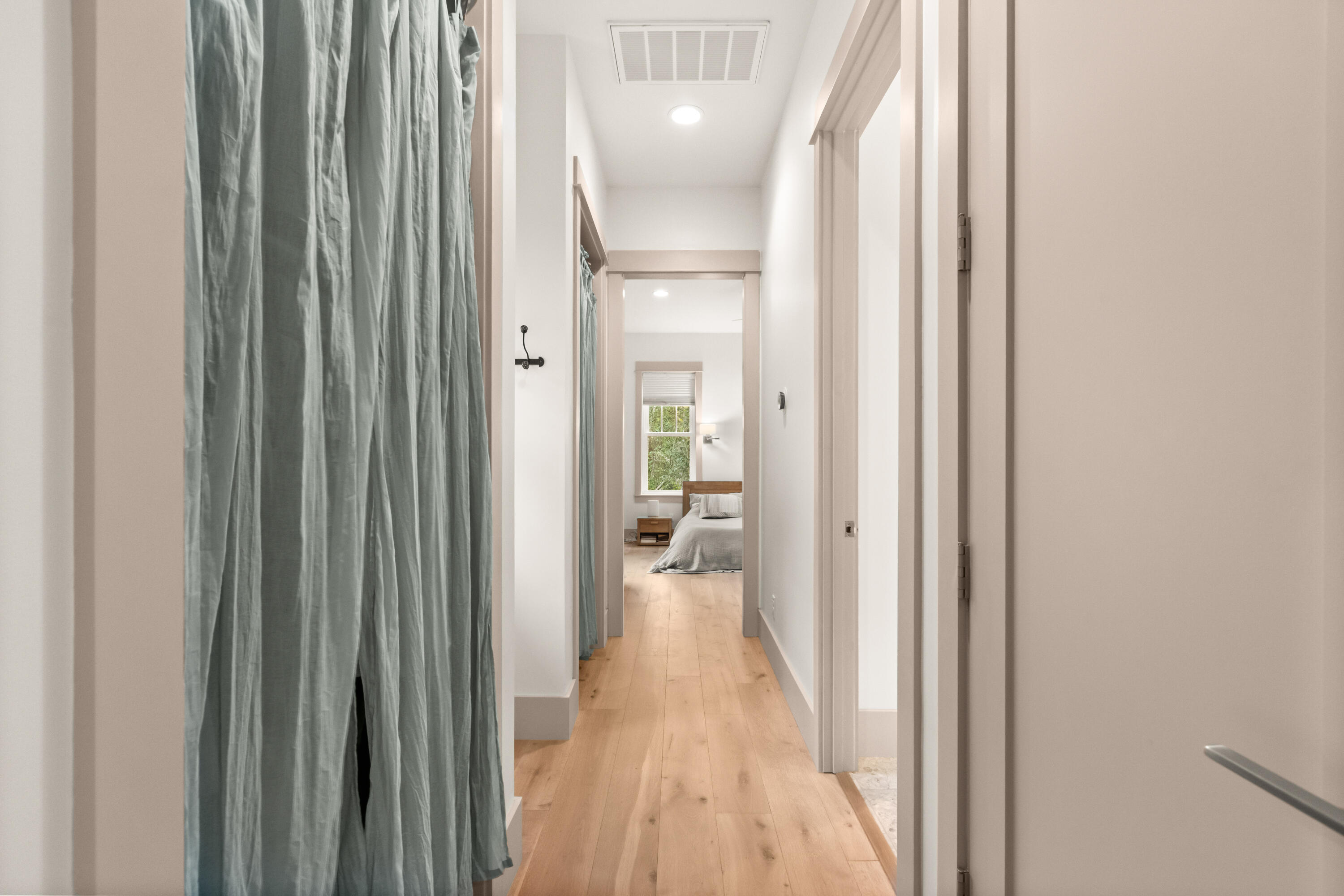 321 Seabreeze Boulevard Seacrest, FL 32461 - Photo 25 of 51 a view of a hallway with wooden floor and a livingroom