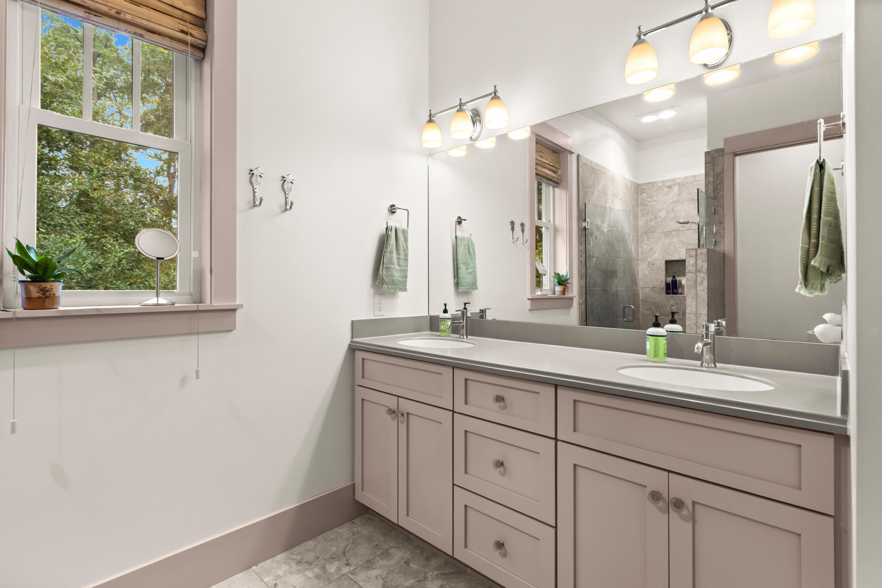 321 Seabreeze Boulevard Seacrest, FL 32461 - Photo 26 of 51 a bathroom with a double vanity sink and a mirror