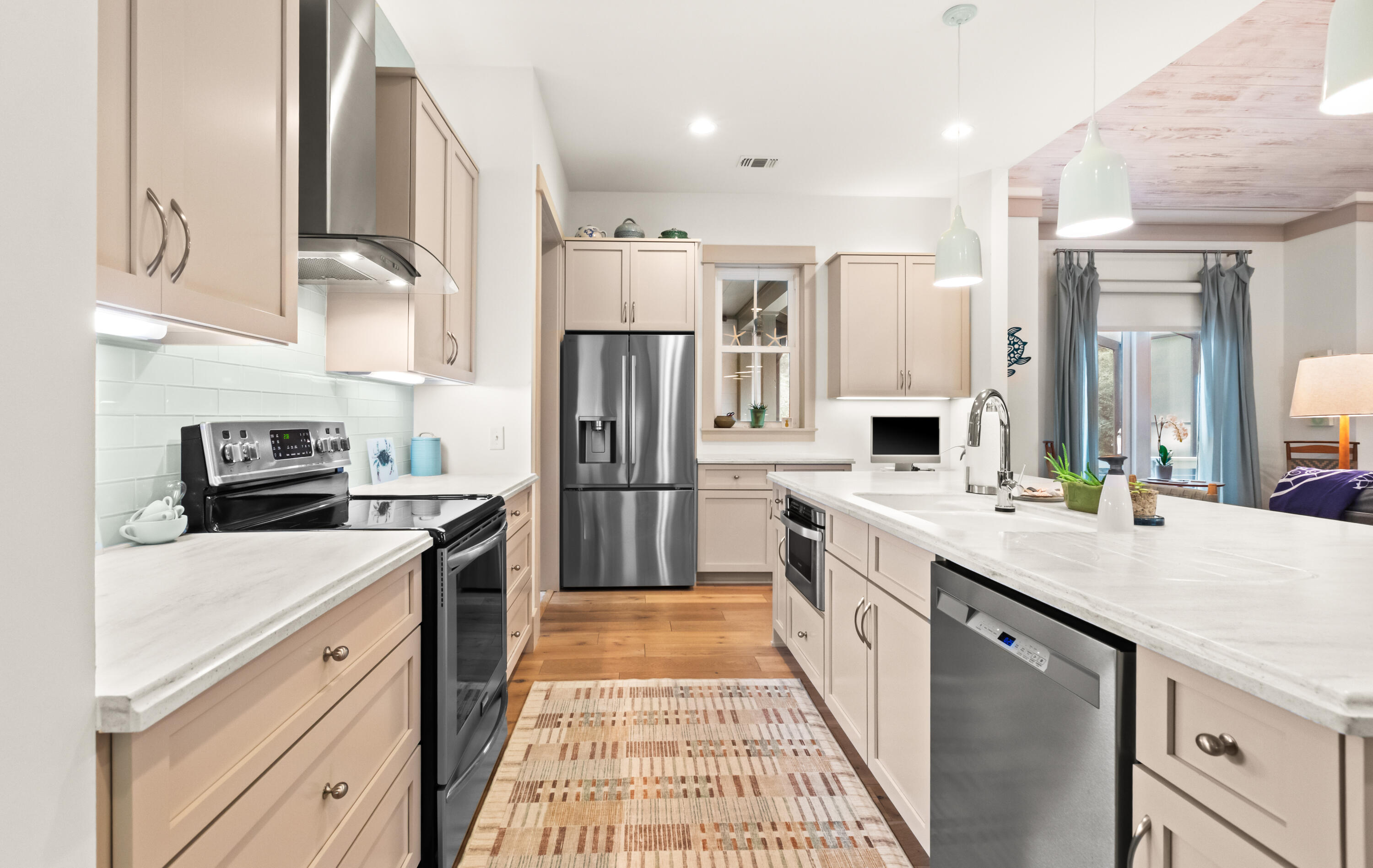 321 Seabreeze Boulevard Seacrest, FL 32461 - Photo 8 of 51 a kitchen with stainless steel appliances a stove refrigerator sink and cabinets