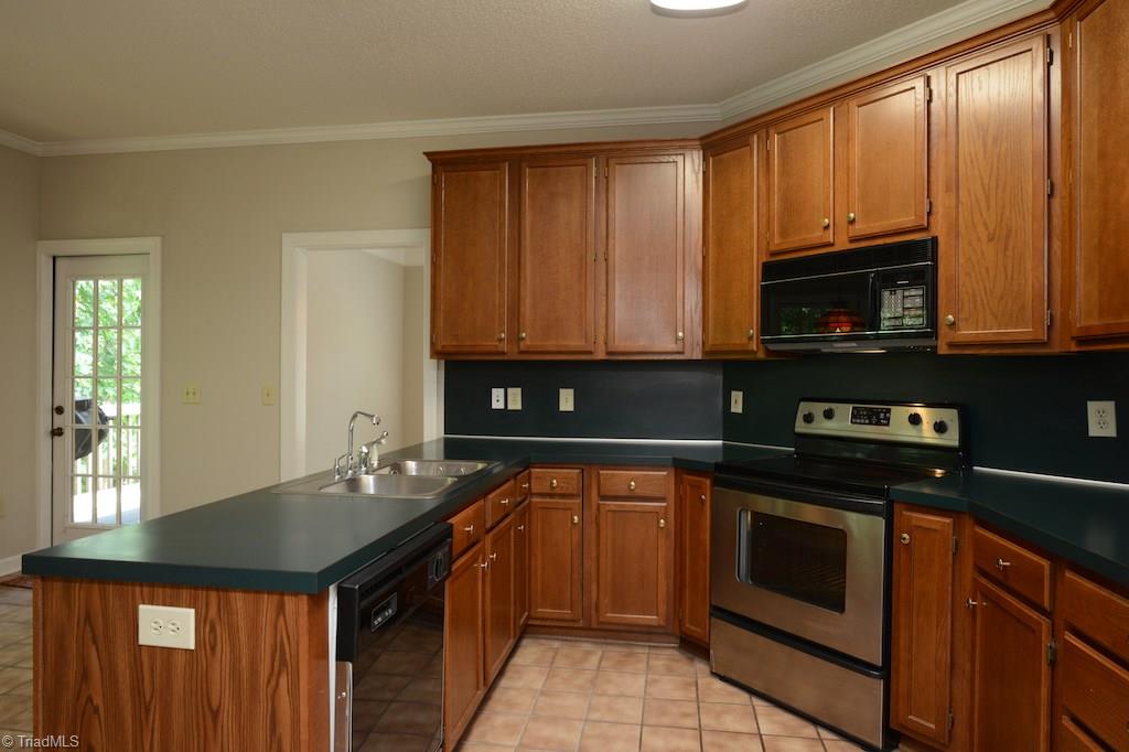 918 Flicker Lane High Point, NC 27262 - Photo 12 of 27 Kitchen with updated SS stove...breakfast room opens onto private deck