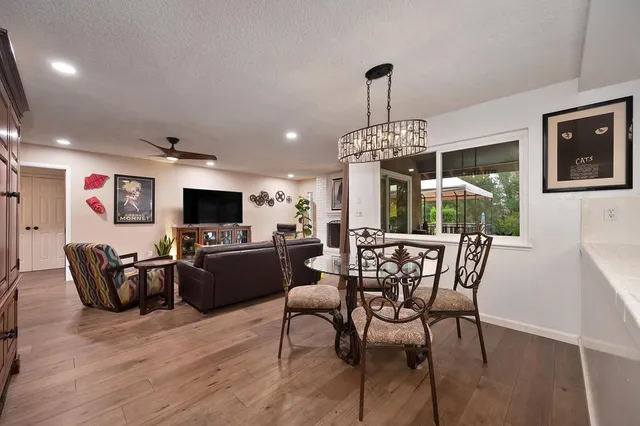 a bedroom with a bed and a dresser next to a window