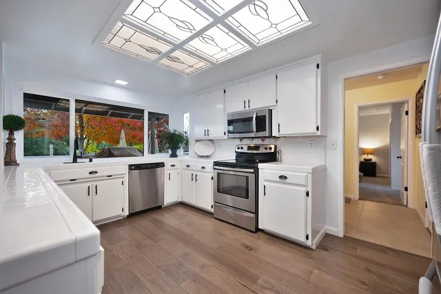 a view of a hallway with bathroom and a livingroom