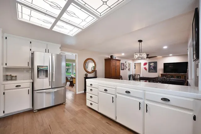 a bedroom with bed and a chandelier