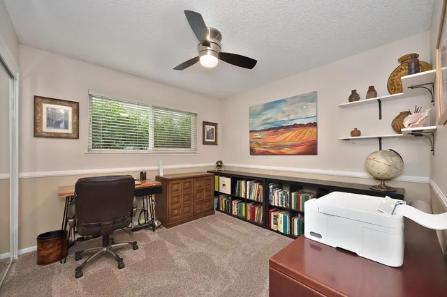 a view of a patio with table and chairs and potted plants
