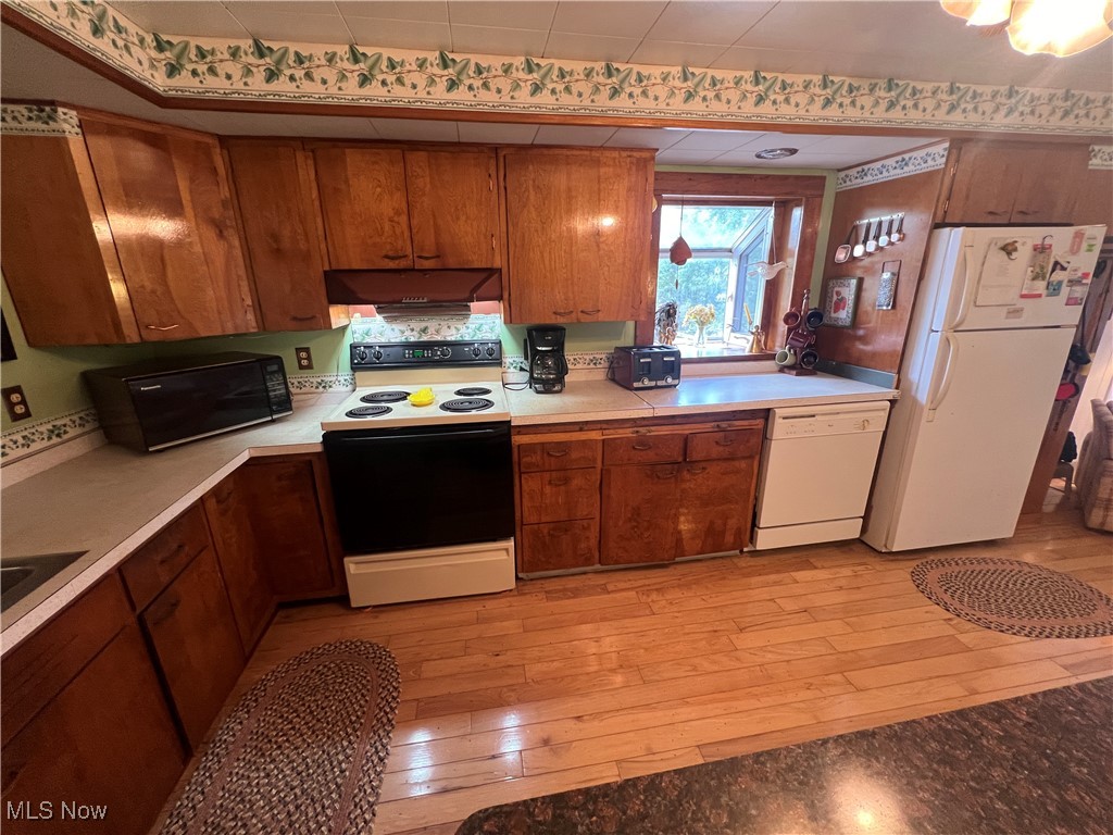 86610 Beaver Dam Road Scio, OH 43988 - Photo 18 of 50 Kitchen with white appliances, light hardwood / wood-style floors, and sink