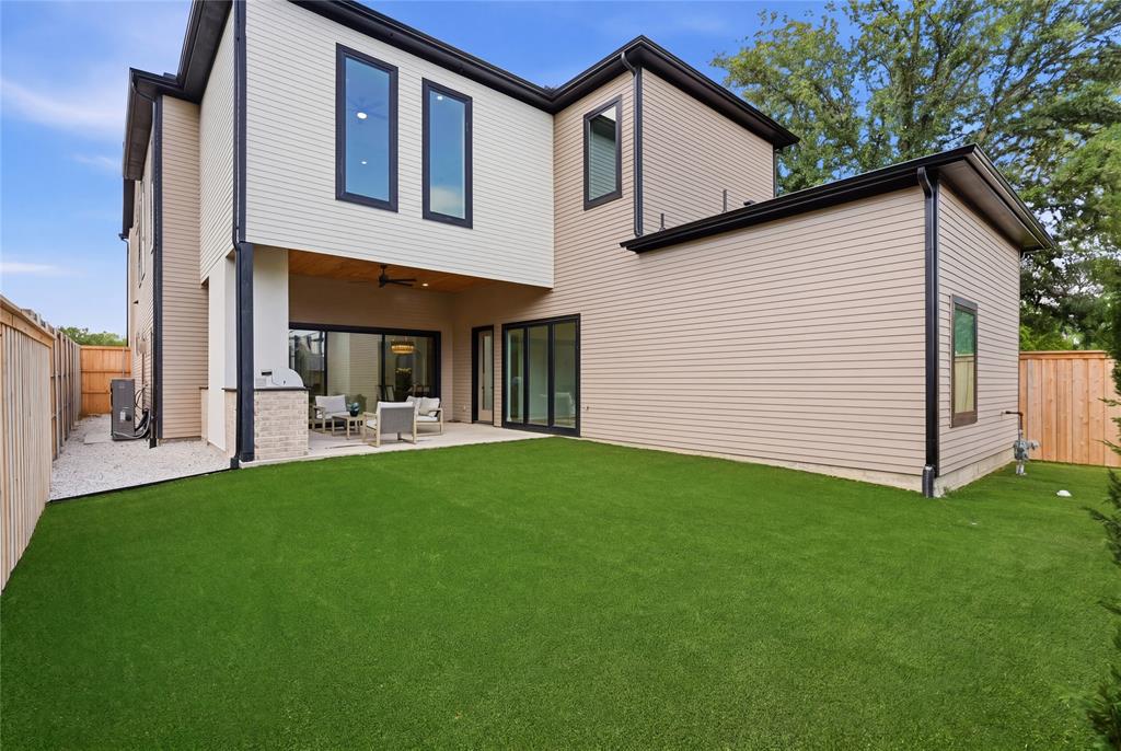 6038 Prospect Avenue Dallas, TX 75206 - Photo 39 of 40 Spacious rear yard featuring an artificial turf lawn and a concrete patio