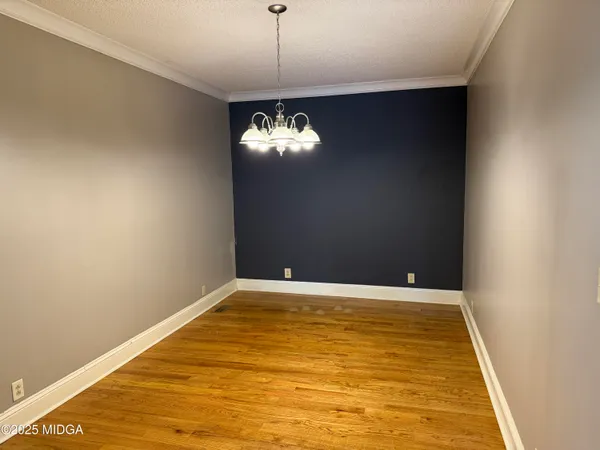 a view of a room with a chandelier fan