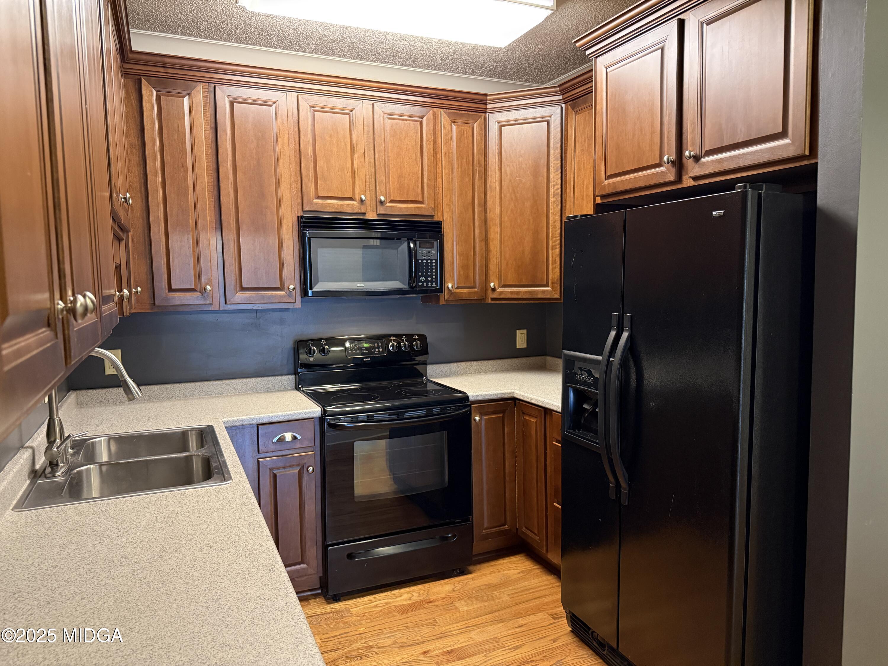 175 Corbin Avenue, Unit A Macon, GA 31204 - Photo 4 of 15 a kitchen with granite countertop a refrigerator stove and microwave
