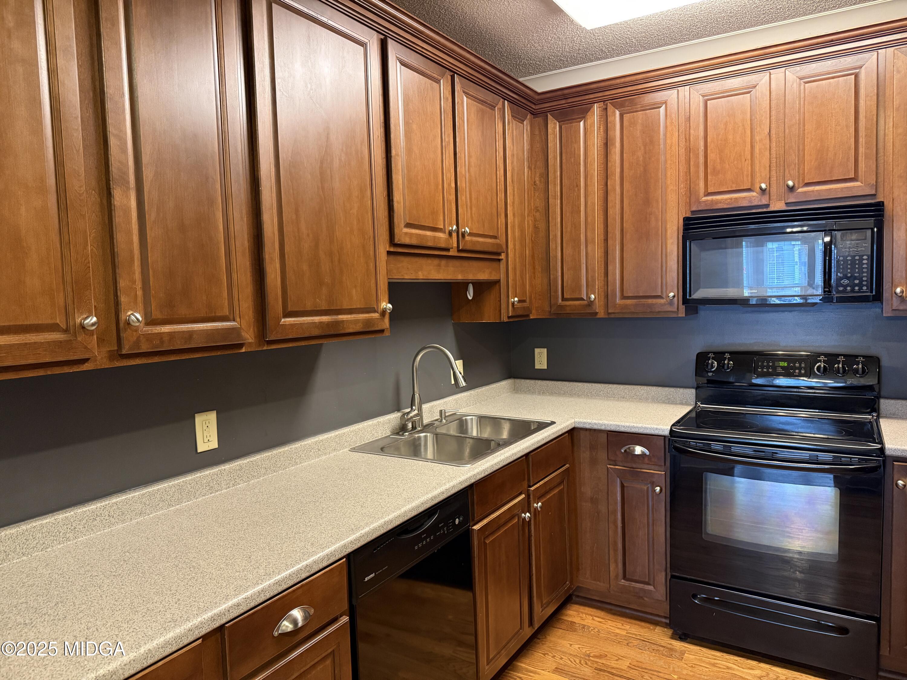 175 Corbin Avenue, Unit A Macon, GA 31204 - Photo 5 of 15 a kitchen with stainless steel appliances granite countertop a sink a stove and a microwave