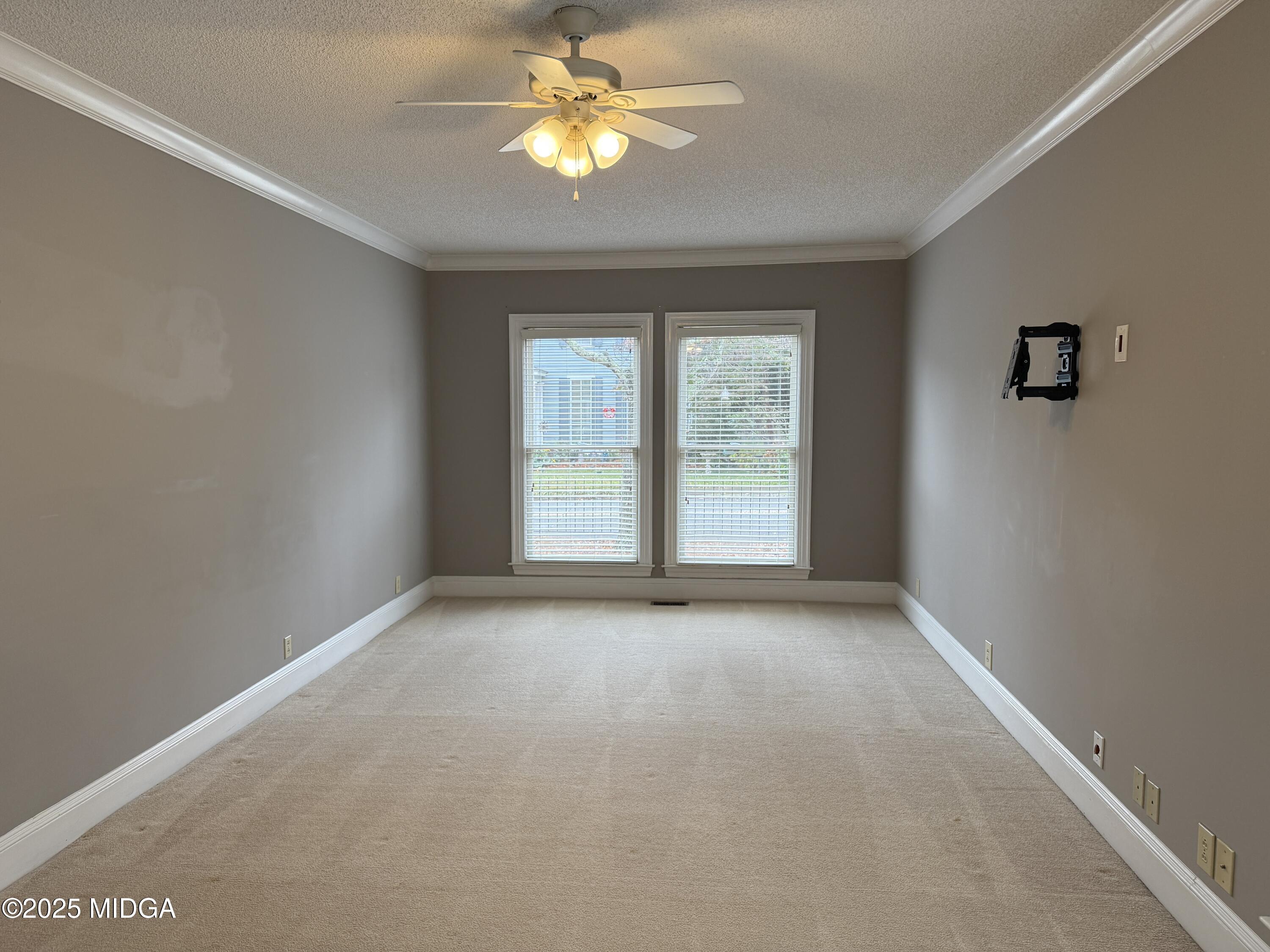 175 Corbin Avenue, Unit A Macon, GA 31204 - Photo 7 of 15 an empty room with windows and chandelier fan