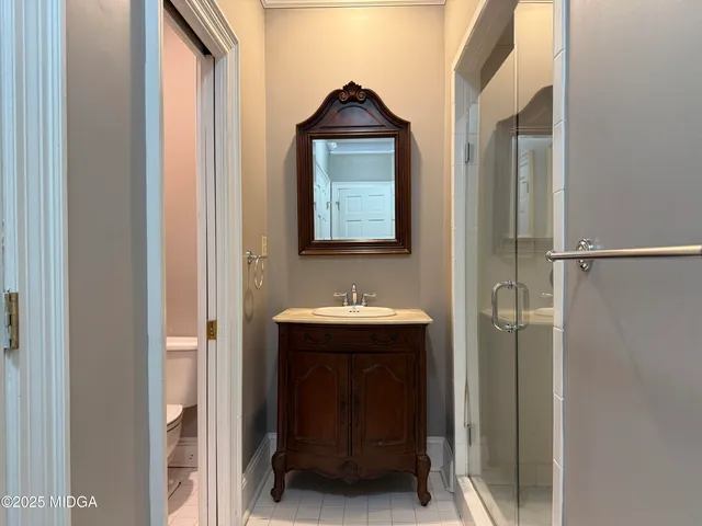 a bathroom with a sink a mirror and a shower