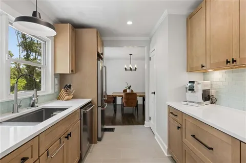 a kitchen with a sink stove and cabinets