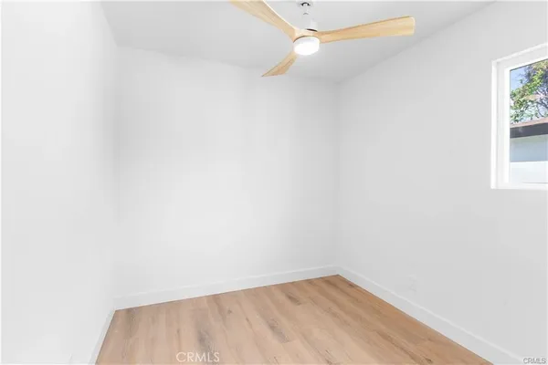 a view of a room with wooden floor and fan