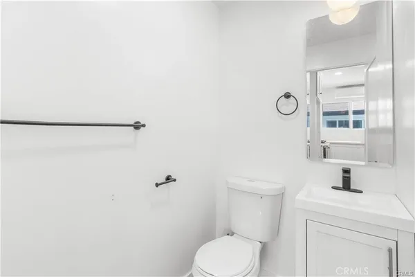a white toilet sitting next to a bathroom sink