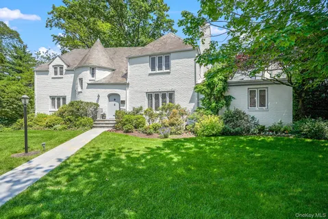 a front view of a house with a garden