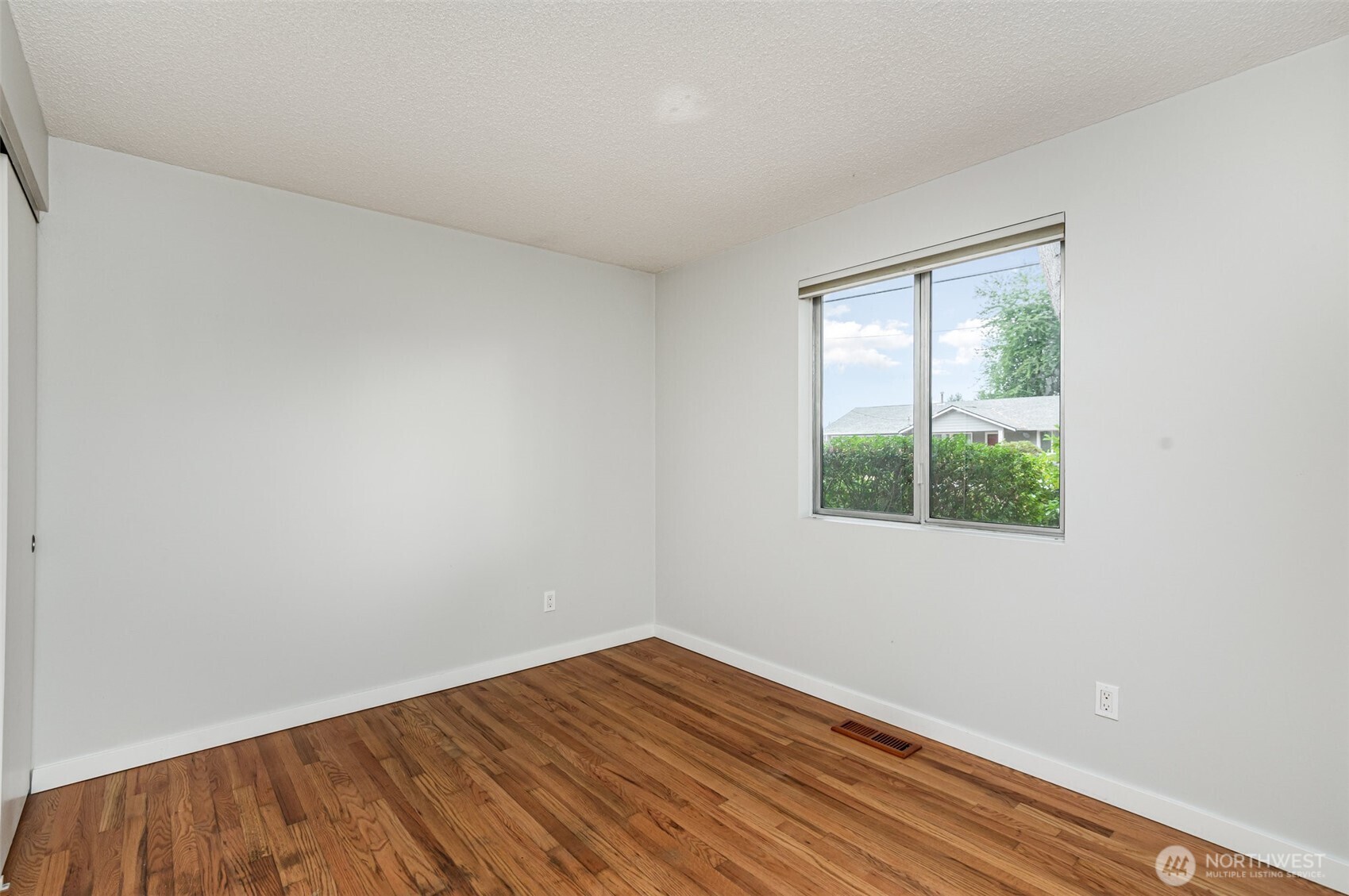 11804 Southeast 165th Street Renton, WA 98058 - Photo 16 of 28 an empty room with wooden floor and windows