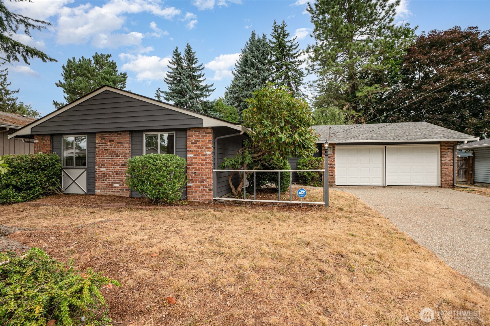 11804 Southeast 165th Street Renton, WA 98058 - Photo 2 of 28 a front view of a house with a garden