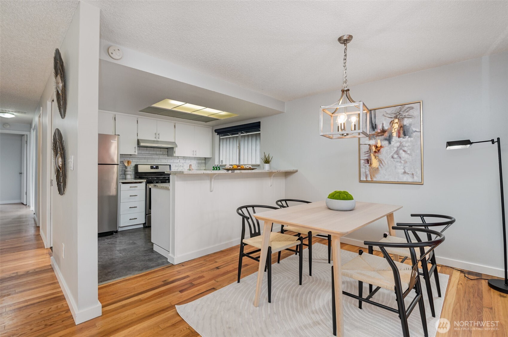11804 Southeast 165th Street Renton, WA 98058 - Photo 9 of 28 a view of kitchen with refrigerator stove and wooden floor