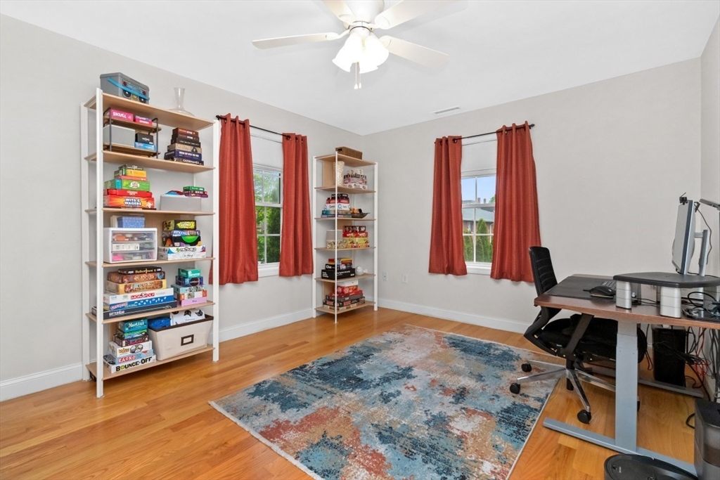 29 Spruce Street, Unit 23 Waltham, MA 02453 - Photo 14 of 26 a bedroom with furniture and a book shelf