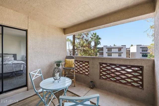 a living room with furniture a table and a large window
