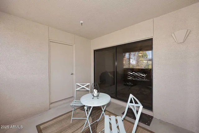 a view of a room with a table and chairs