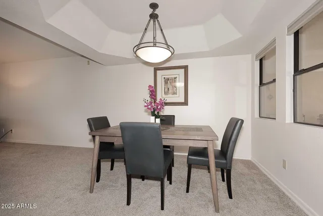 a view of a dining room with furniture and a chandelier
