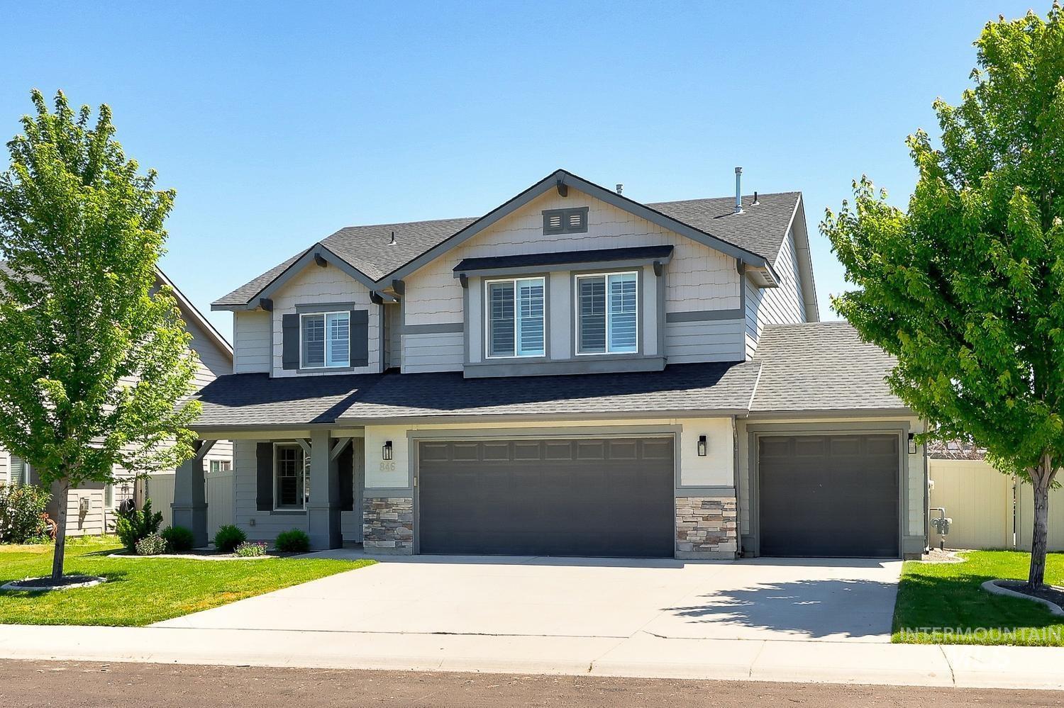 846 North Hidden View Way Star, ID 83669 - Photo 1 of 49 Contemporary two-story residence featuring a multi-tone exterior, an attached three-car garage, stone accents, a covered front porch, and mature landscaping