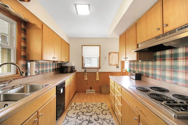 a kitchen with a sink stove and cabinets