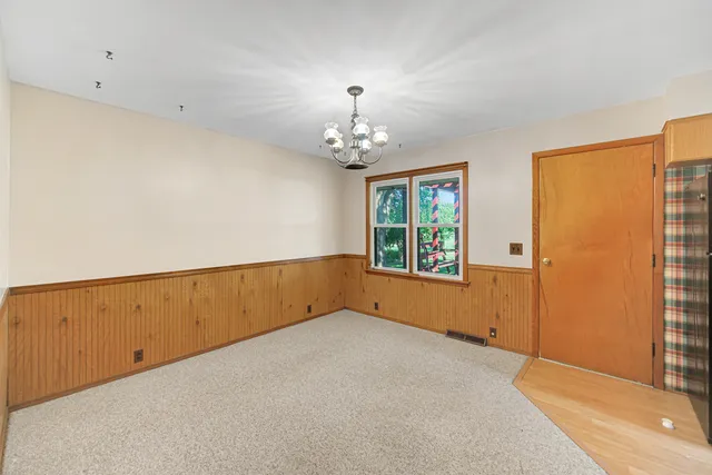 a view of kitchen with refrigerator and window