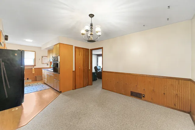 a bedroom with a bed and a chair