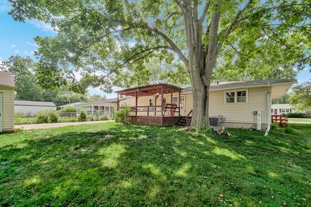 a view of backyard with a garden and deck