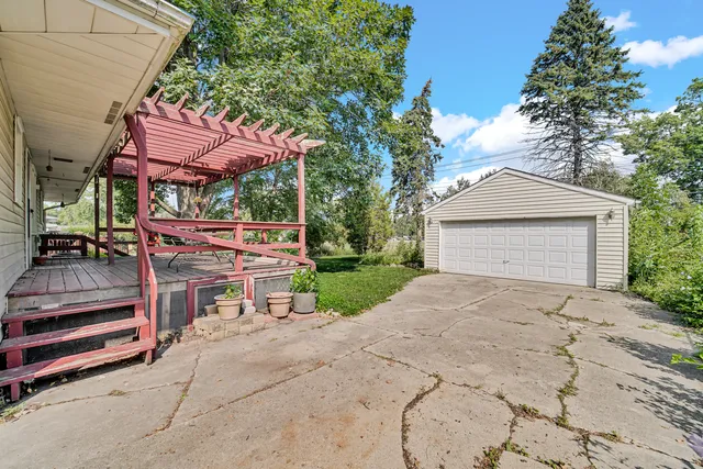 a view of a patio with a table and chairs under an umbrella