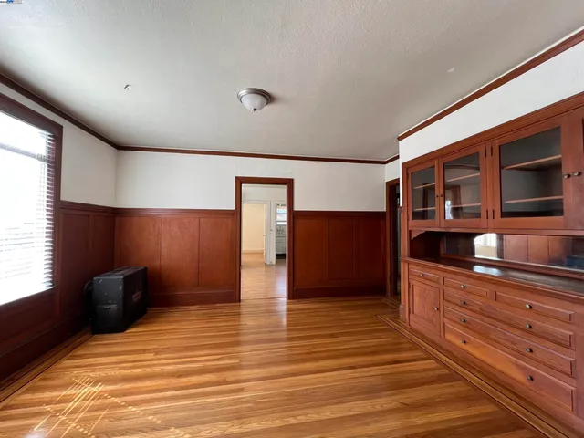 a view of room with wooden floor and flat screen tv