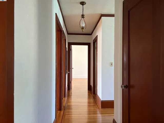 a view of a hallway view with wooden floor and staircase