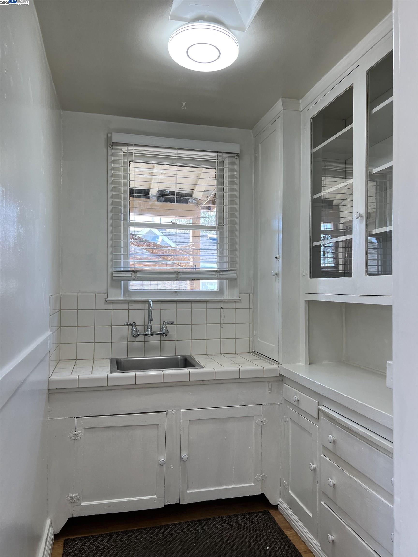 1301 9th Street Alameda, CA 94501 - Photo 7 of 12 a bathroom with a sink and a window