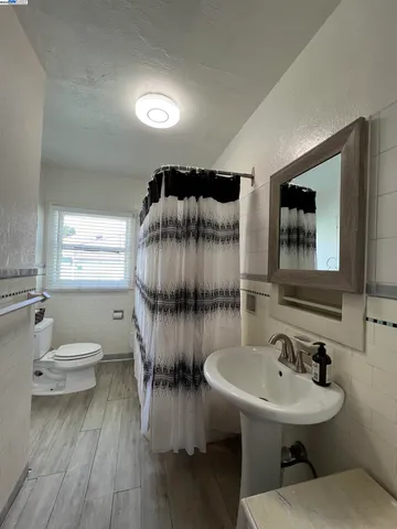 a bathroom with a sink mirror and toilet