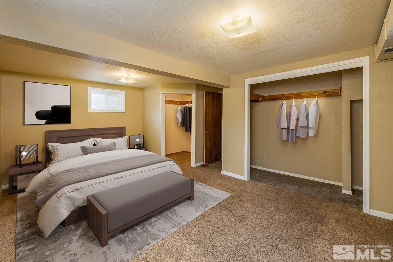 120 Caliente Street Reno, NV 89509 - Photo 16 of 20 a spacious bedroom with a bed and wall painting
