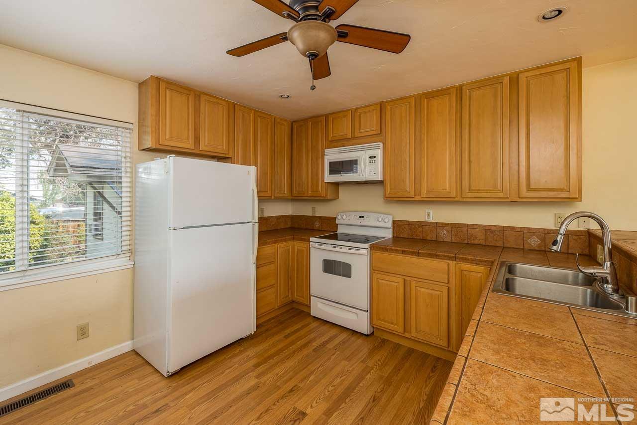 120 Caliente Street Reno, NV 89509 - Photo 4 of 20 a kitchen with a refrigerator sink and cabinets