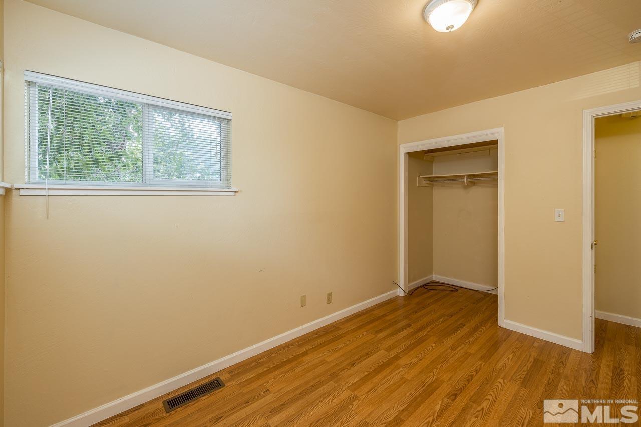 120 Caliente Street Reno, NV 89509 - Photo 9 of 20 an empty room with wooden floor and windows