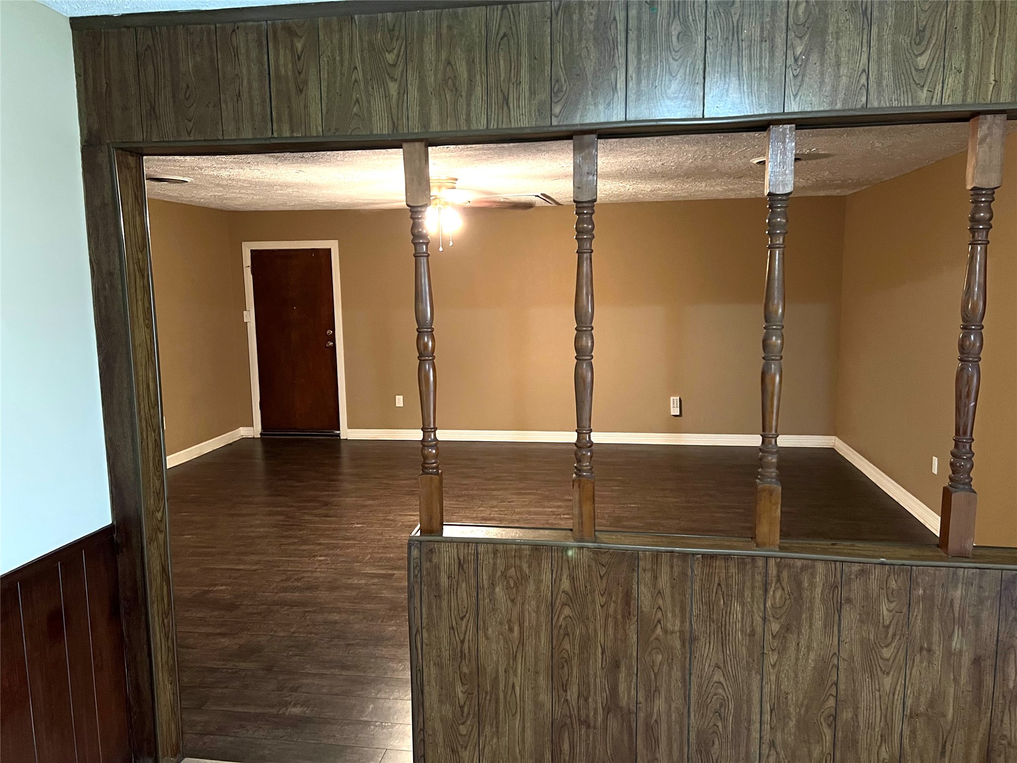 514 West Sunnyside Street Houston, TX 77091 - Photo 6 of 8 an empty room with wooden floor and windows